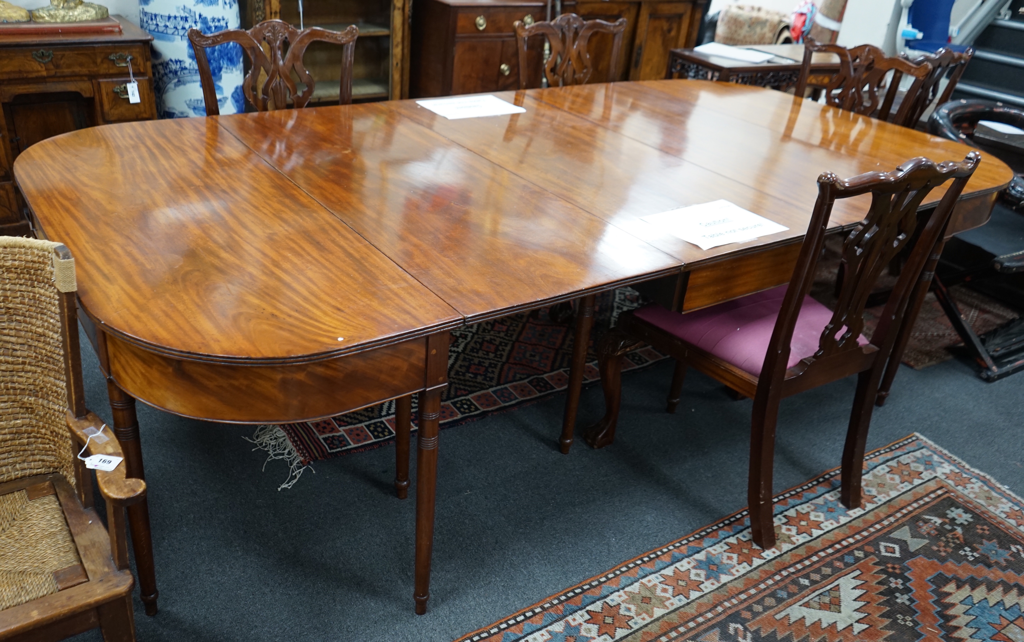 A George III mahogany D end extending dining table and six reproduction Chippendale style mahogany dining chairs, table 275cm extended, width 137cm height 74cm